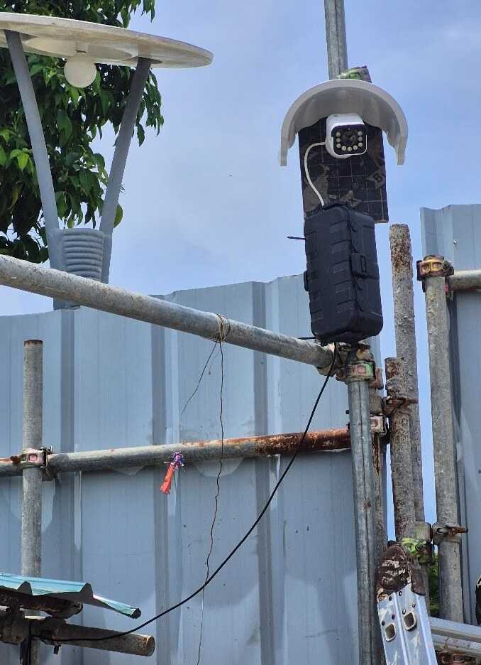 Reolink construction camera, weather hood and protected network box mounted on scaffolding