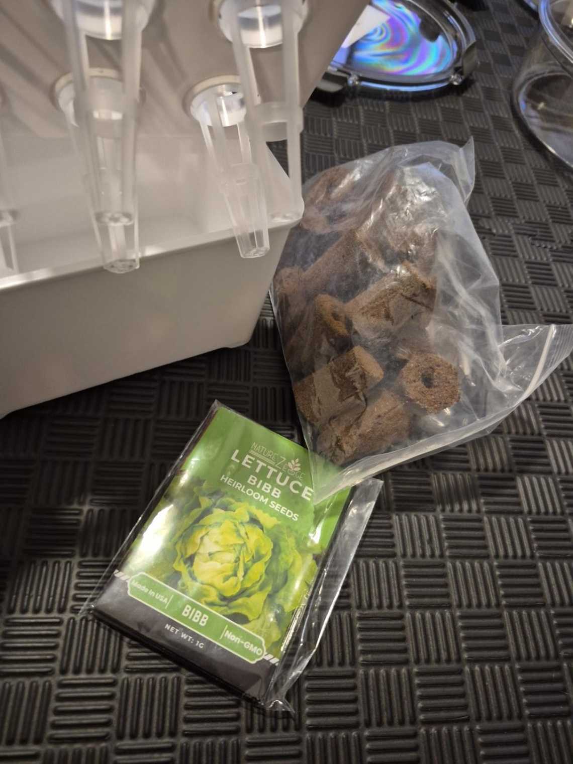 Bibb lettuce seed packet, hydroponic growing sponges and the small indoor hydroponic unit