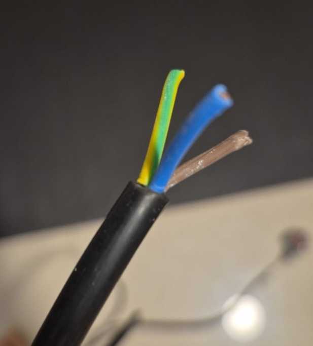 UK plug with exposed wires ready for connection, three-core cable showing brown (live), blue (neutral), and green-yellow (earth) wires